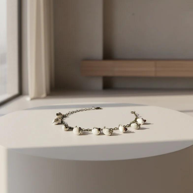 Cowrie shell anklet bracelet displayed on neutral decor surface coastal handmade jewelry