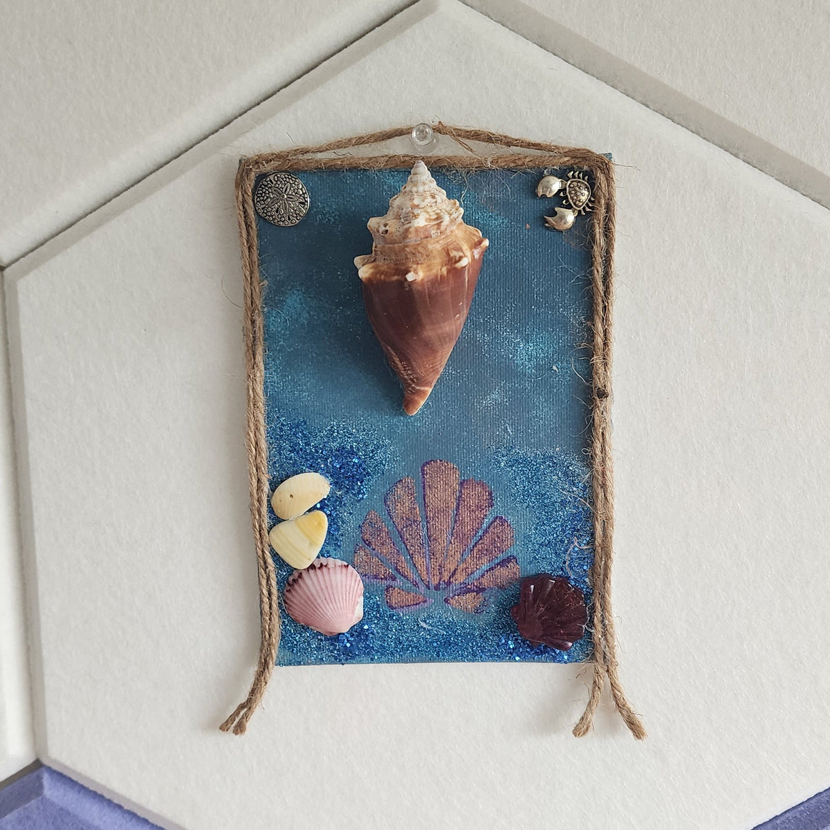 Conch & Charms seashell jewelry holder wall decor with silver charms, handmade coastal wall art