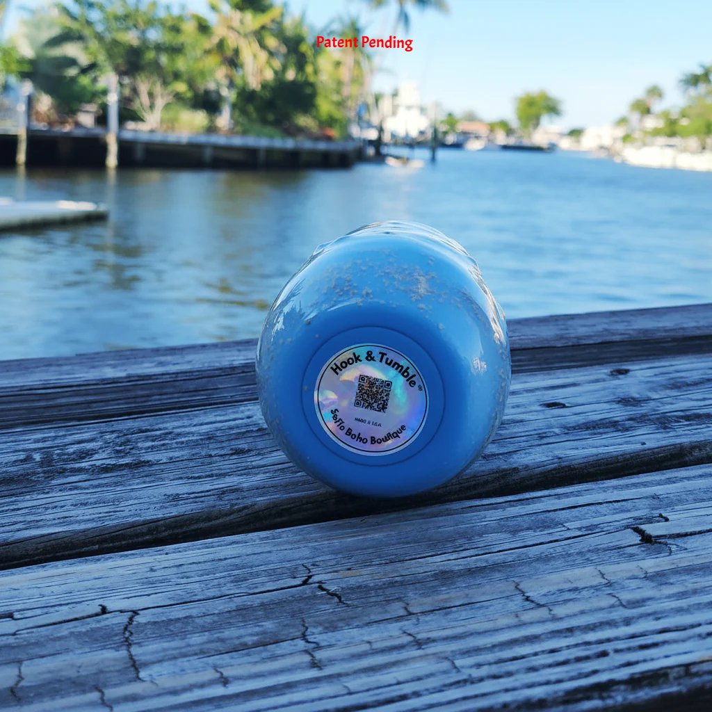 Close-up base of Hook & Tumble™ Blue Tide tumbler showing crushed sand and hook detail in clear epoxy