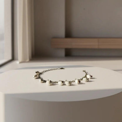 Cowrie shell anklet bracelet displayed on neutral decor surface coastal handmade jewelry