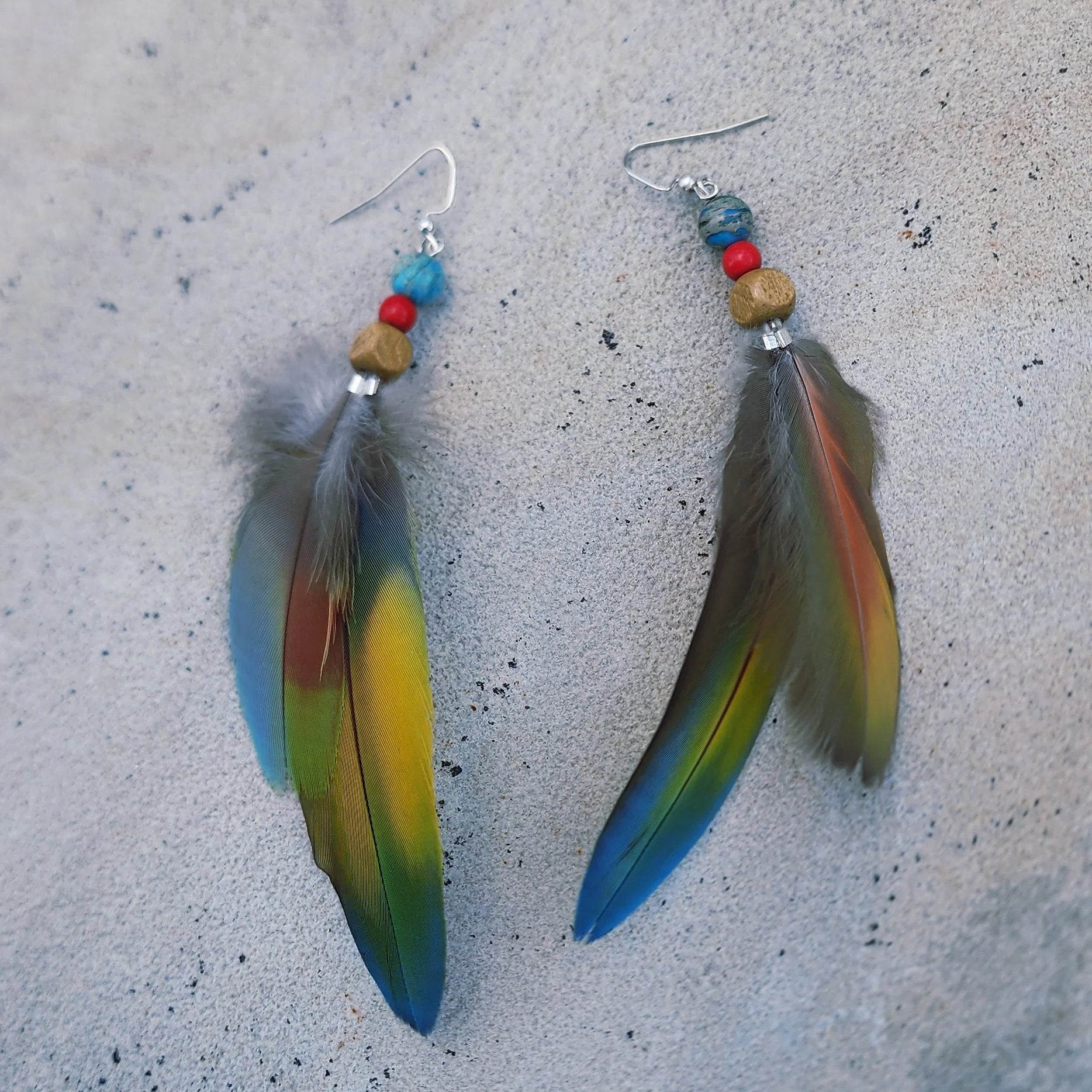 Double feather Earring displayed on stone