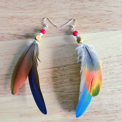 Handmade blue green feather earrings with white howlite, wood, and coral-colored beads, long coastal dangle earrings