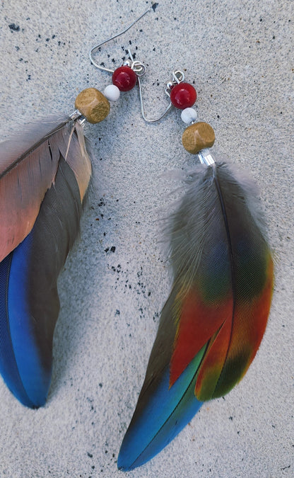 Handmade blue green feather earrings with white howlite, wood, and coral-colored beads, long coastal dangle earrings