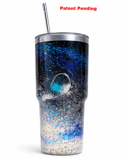 30oz black fishing hook tumbler with real sand and blue glitter epoxy finish displayed on beach sand
