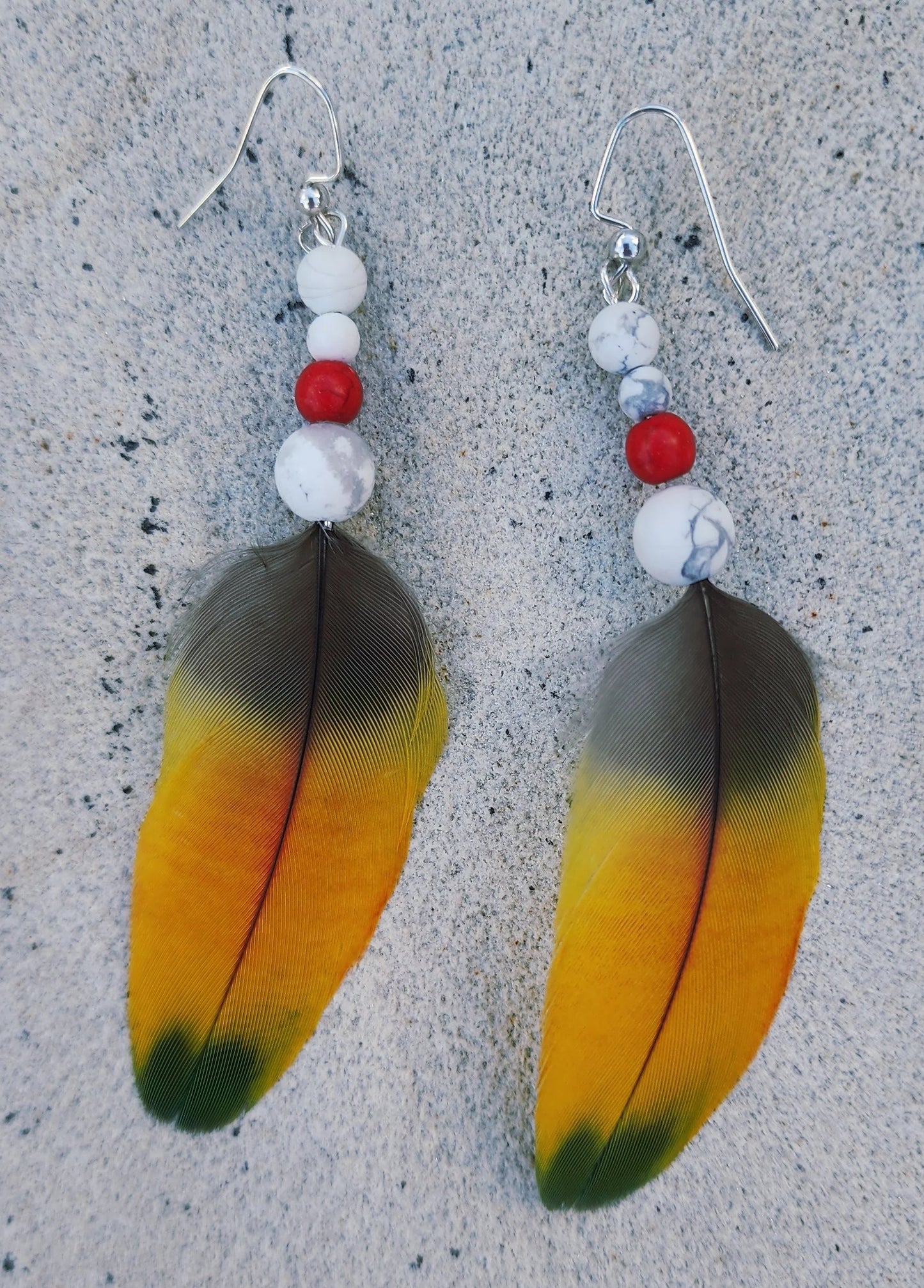 Yellow Feather Earring with white howlite and coral red beadclose up