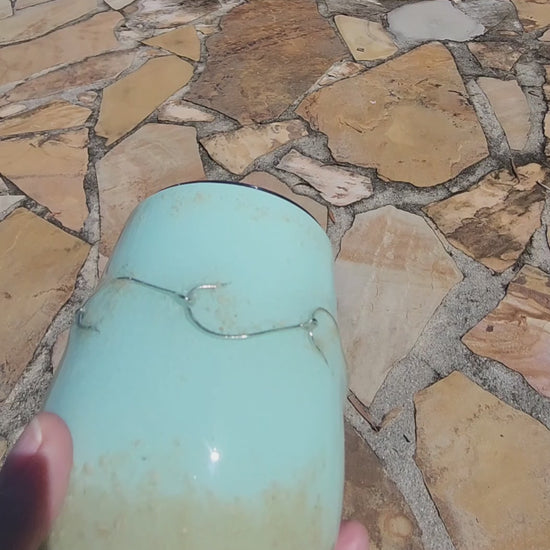 Video of a handmade 12oz teal fishing hook tumbler with real fishing hooks and sand held in hand