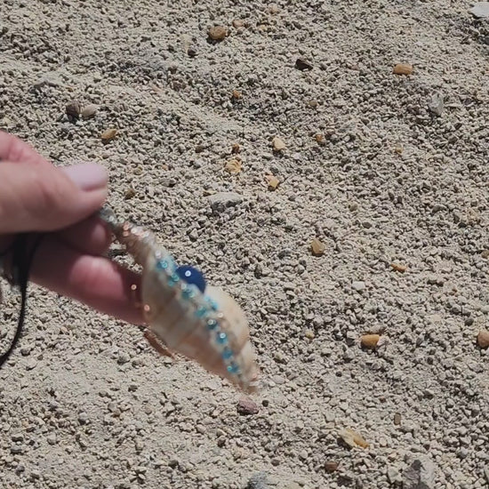 Handmade tulip shell pendant necklace with copper wire wrap, blue ceramic bead, and glass beads on cord
