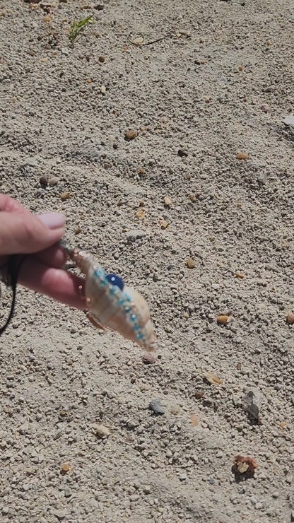 Handmade tulip shell pendant necklace with copper wire wrap, blue ceramic bead, and glass beads on cord