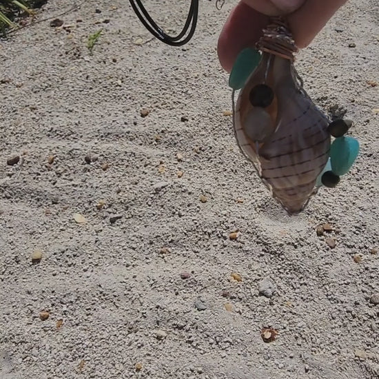 Handmade tulip shell pendant necklace with mixed metal wire wrap, turquoise beads, and wood accents on cord - video