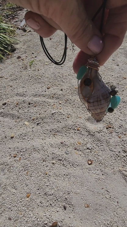 Handmade tulip shell pendant necklace with mixed metal wire wrap, turquoise beads, and wood accents on cord - video