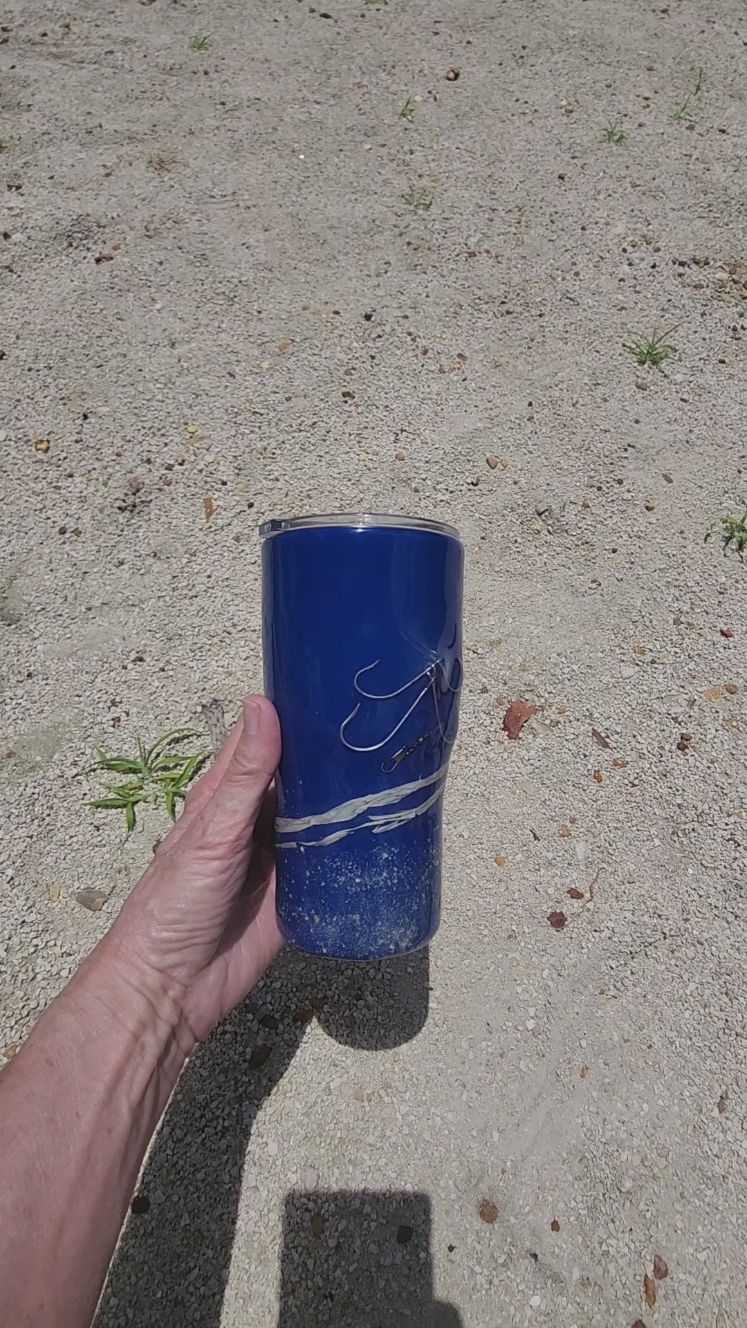 Video of handmade 20oz Blue Ink fishing hook tumbler with real saltwater hooks, barrel swivel and natural raffia, Hook & Tumble coastal drinkware
