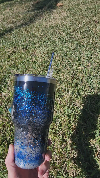 Saltwater Surge 30oz fishing hook tumbler with layered blue glitter and real sand epoxy design on beach