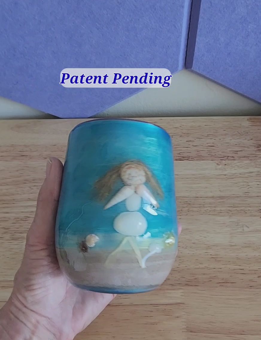 close view of a handmade shell people wine tumbler held in hand, real shells and glossy finish
