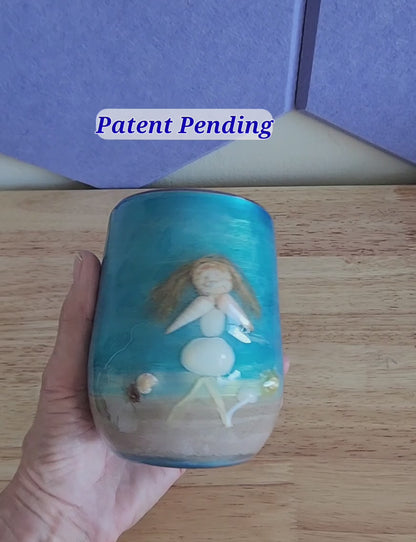 close view of a handmade shell people wine tumbler held in hand, real shells and glossy finish