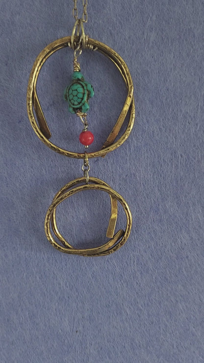 Video of handmade brass turtle pendant necklace showing hammered texture detail
