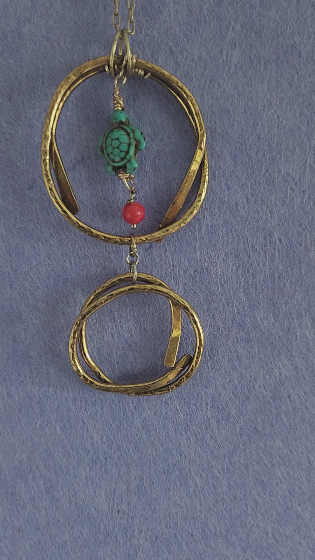 Video of handmade brass turtle pendant necklace showing hammered texture detail