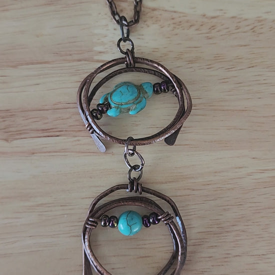 Copper pendant necklace with turquoise howlite turtle and metallic prurple glass beads - video close up