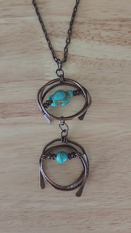 Copper pendant necklace with turquoise howlite turtle and metallic prurple glass beads - video close up