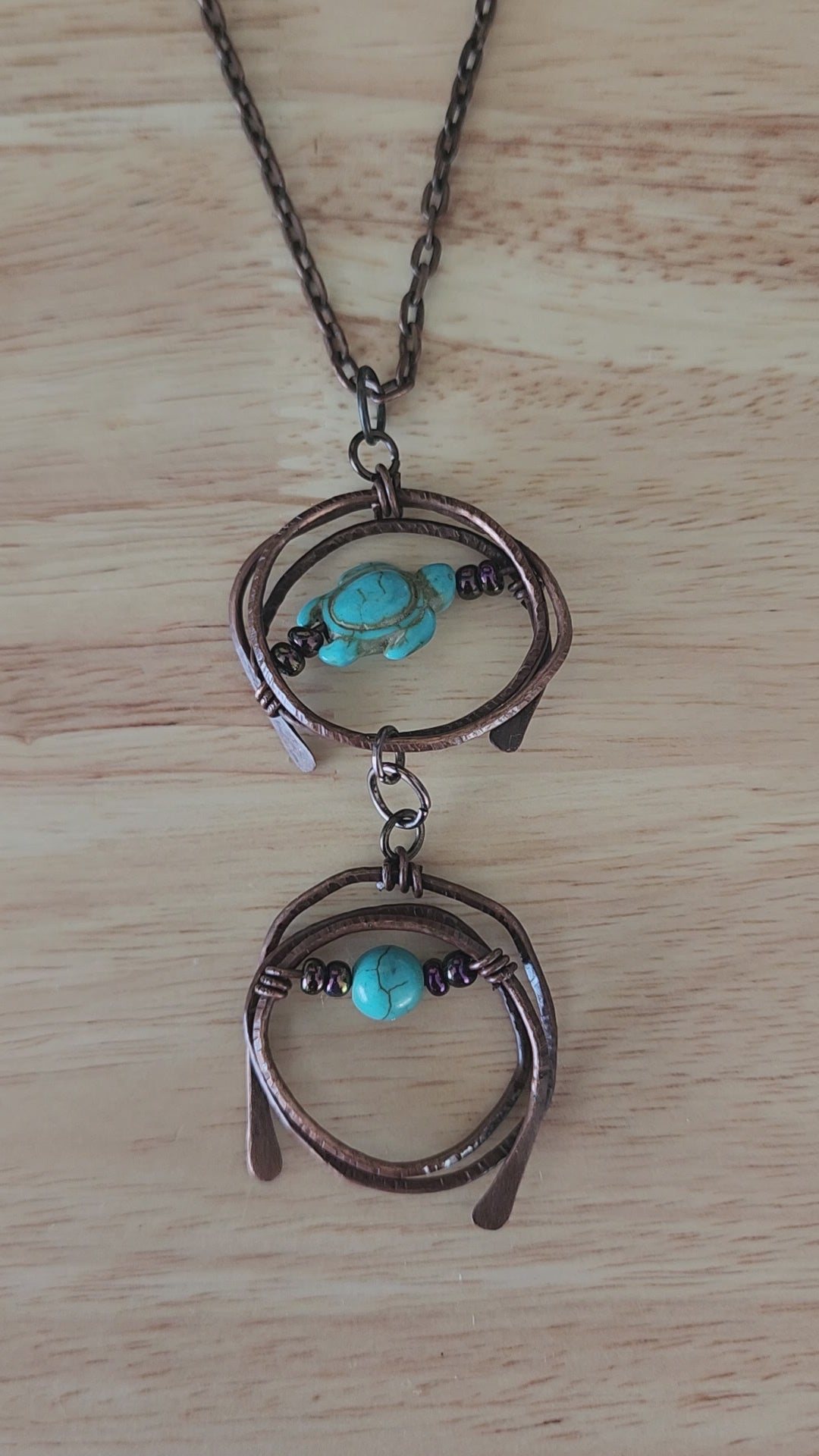 Copper pendant necklace with turquoise howlite turtle and metallic prurple glass beads - video close up