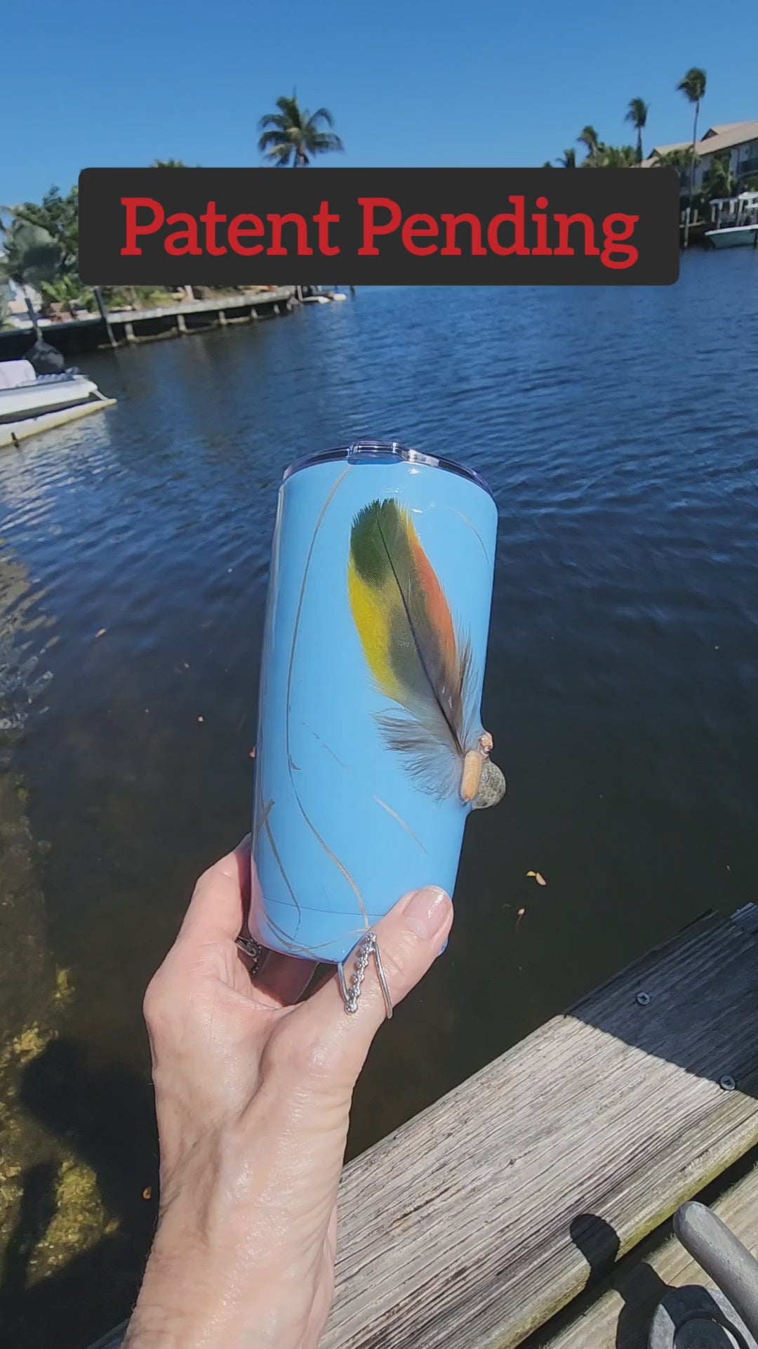 Blue Saltwater Sips seashell tumbler on dock by water – handmade coastal cowgirl drinkware 20oz