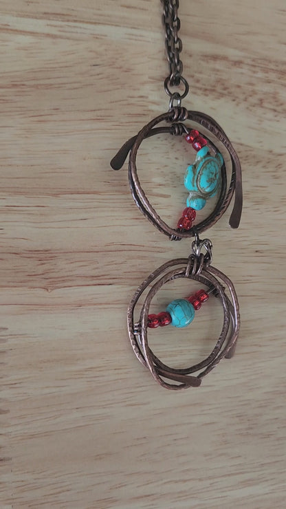 Copper pendant necklace with turquoise howlite turtle and red glass beads -video close up
