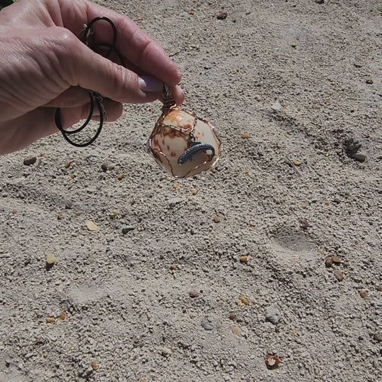 Seashell pendant necklace with fish charm and wire wrap on cord