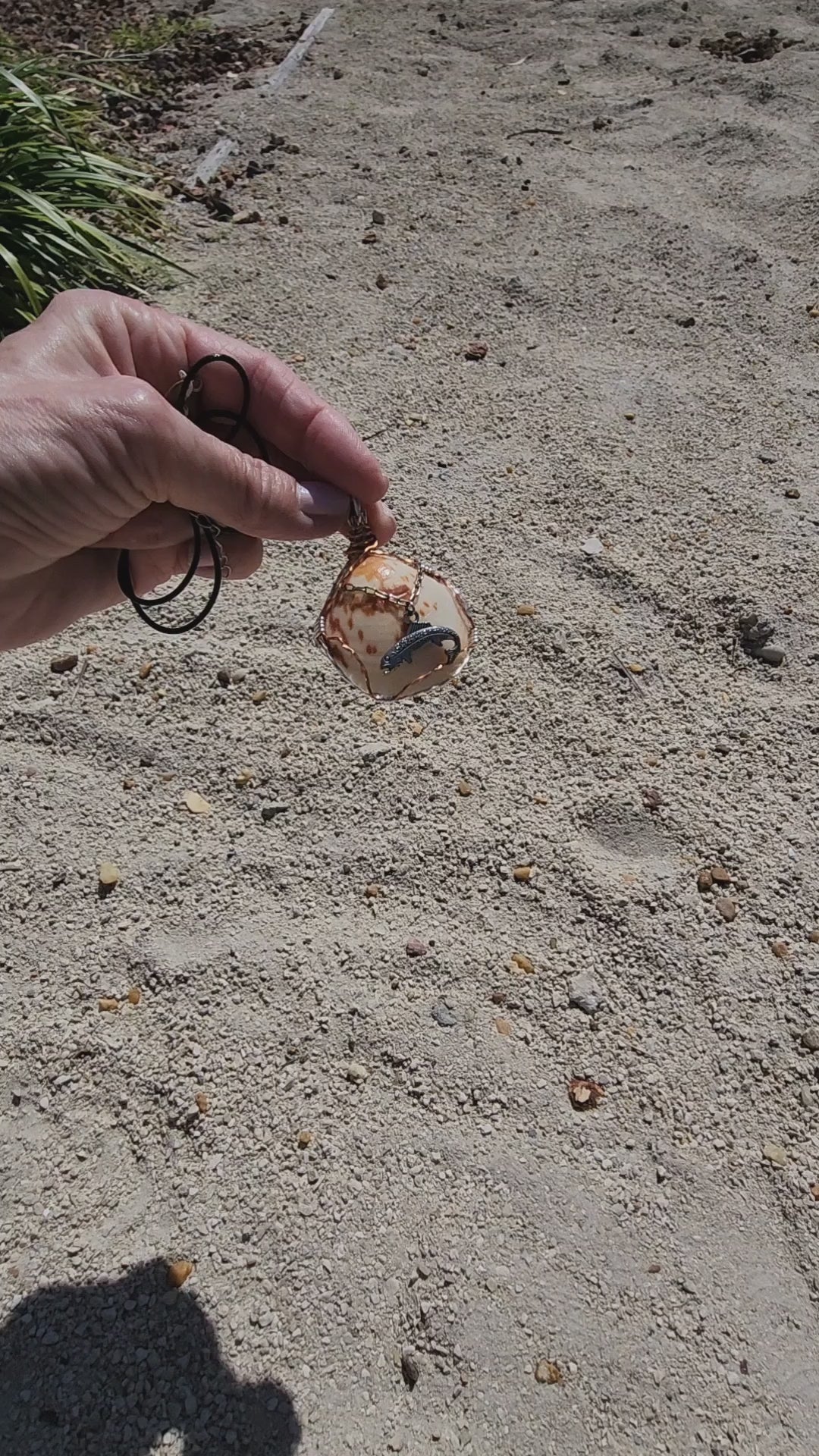 Seashell pendant necklace with fish charm and wire wrap on cord