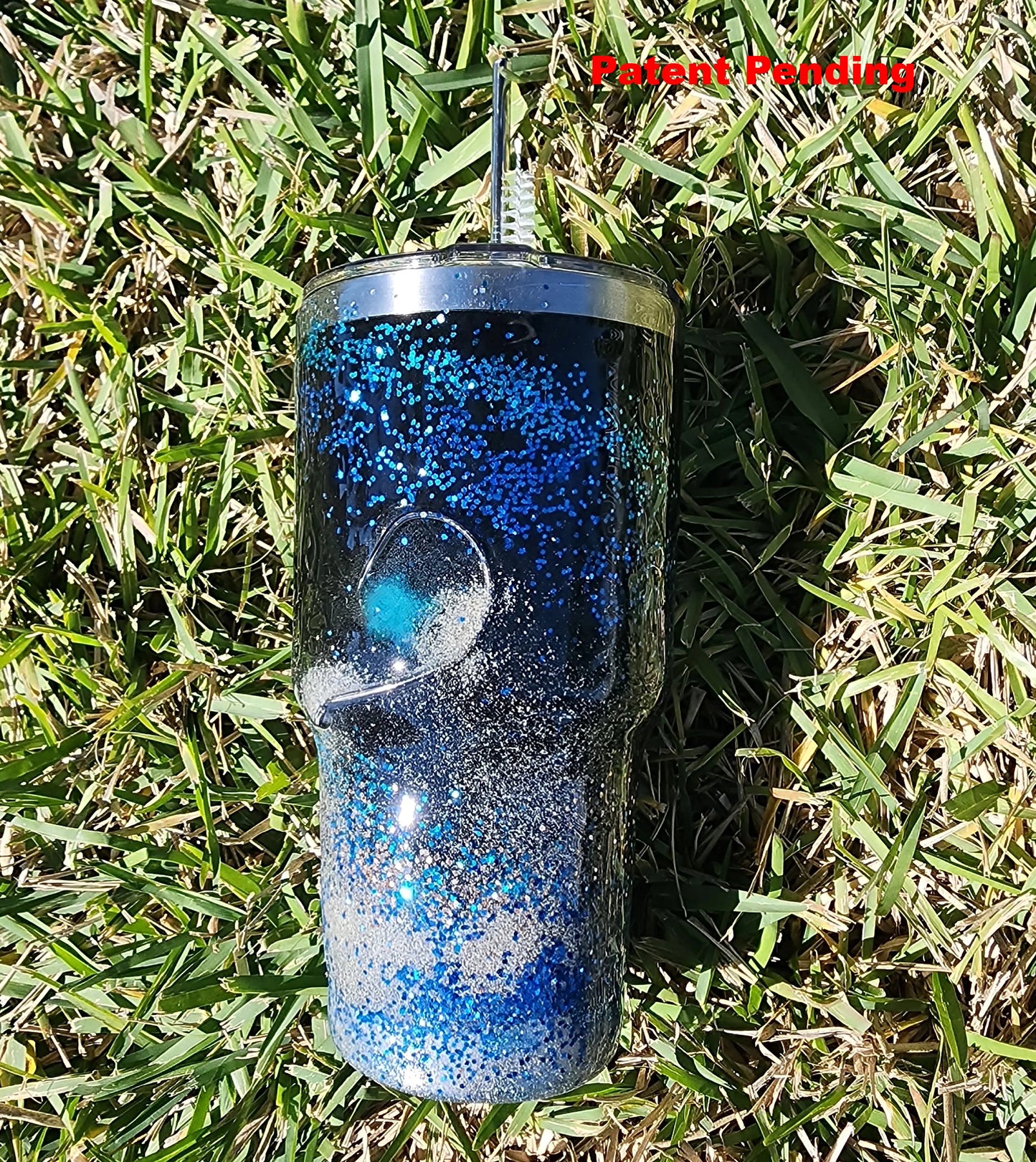 Saltwater Surge 30oz fishing hook tumbler with layered blue glitter and real sand epoxy design on beach