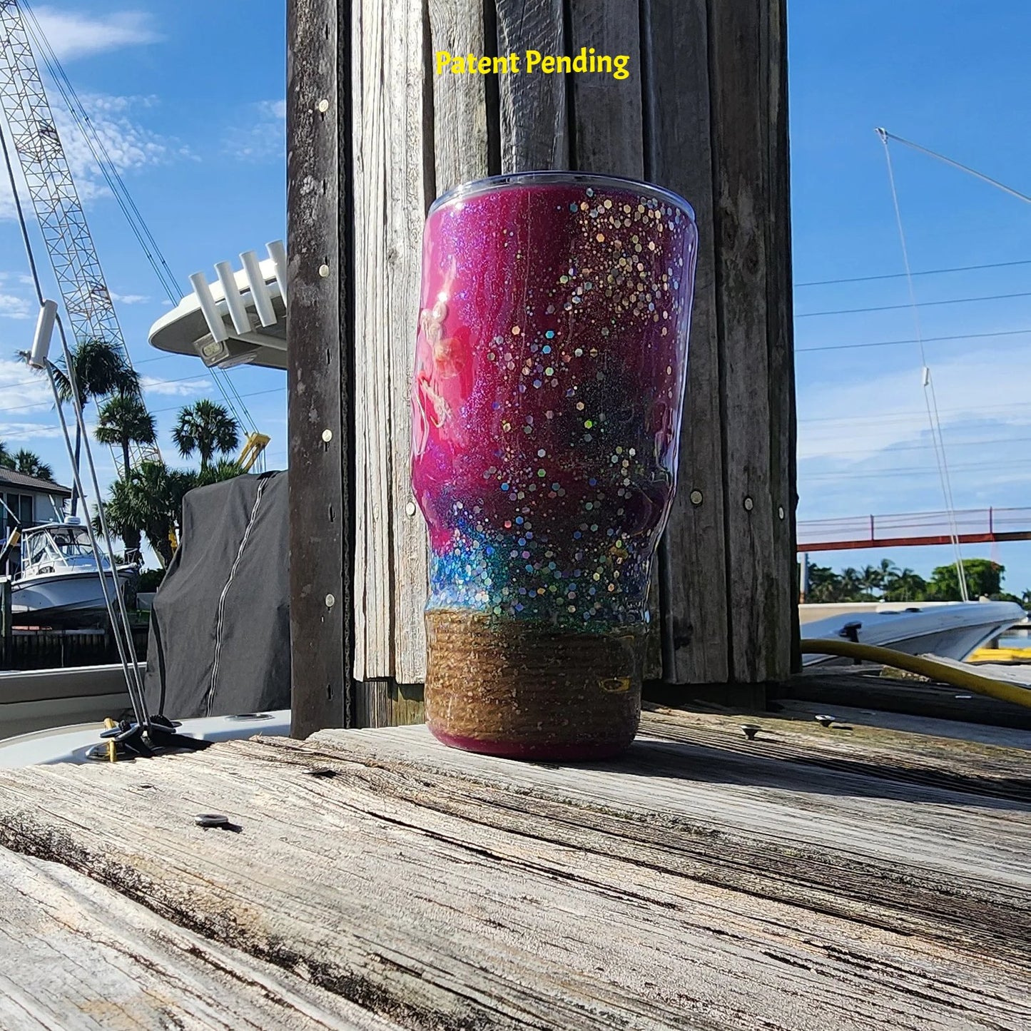 Magenta Tide fishing tumbler for her outdoor shot showing full body magenta epoxy with rope wrapped base and green glitter detail