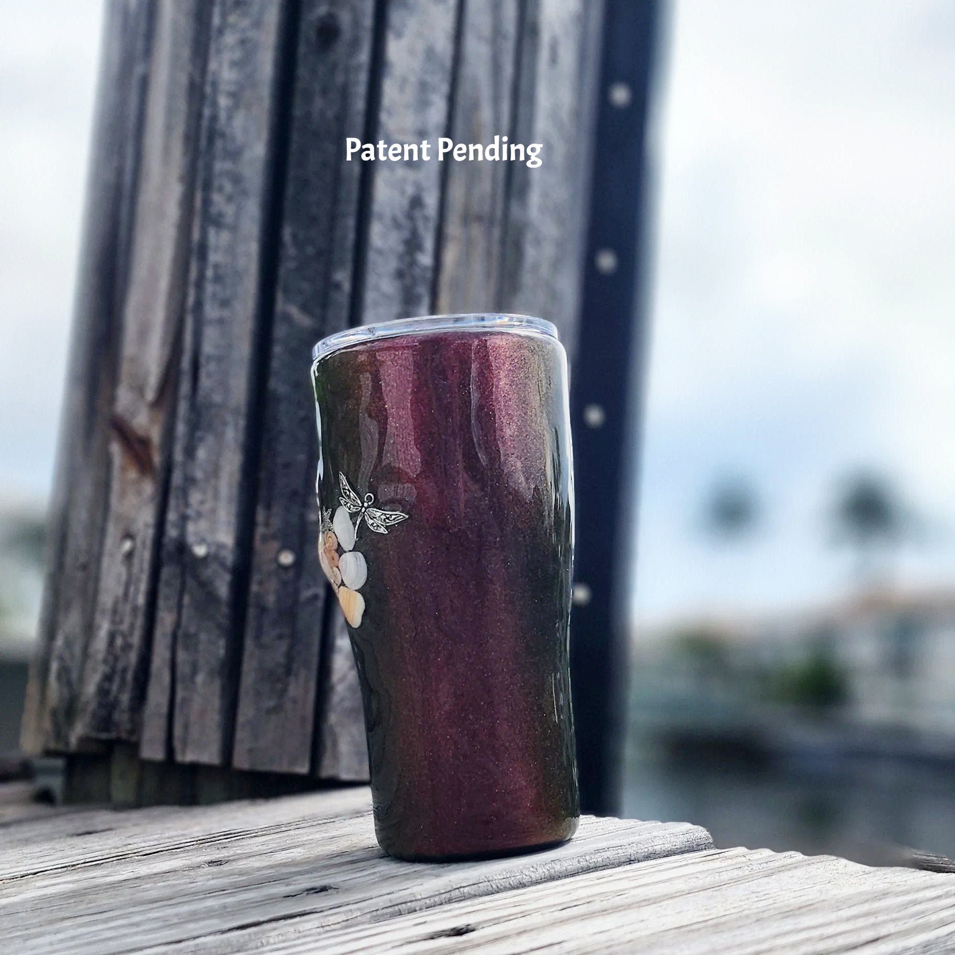 Left view of curve-shape stainless steel tumbler with real Florida seashells and dragonfly charm