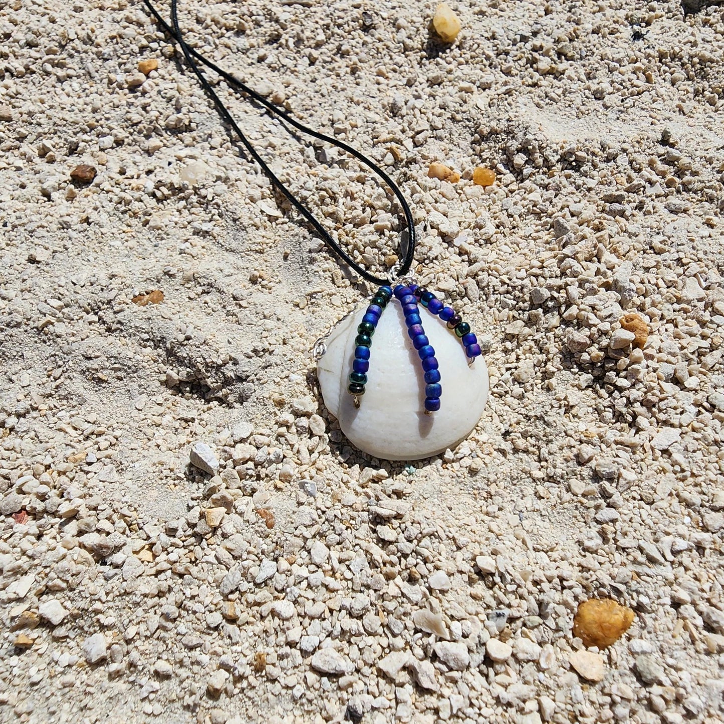 Handmade Lucina shell pendant necklace with silver wire wrap and multicolor bead strands
