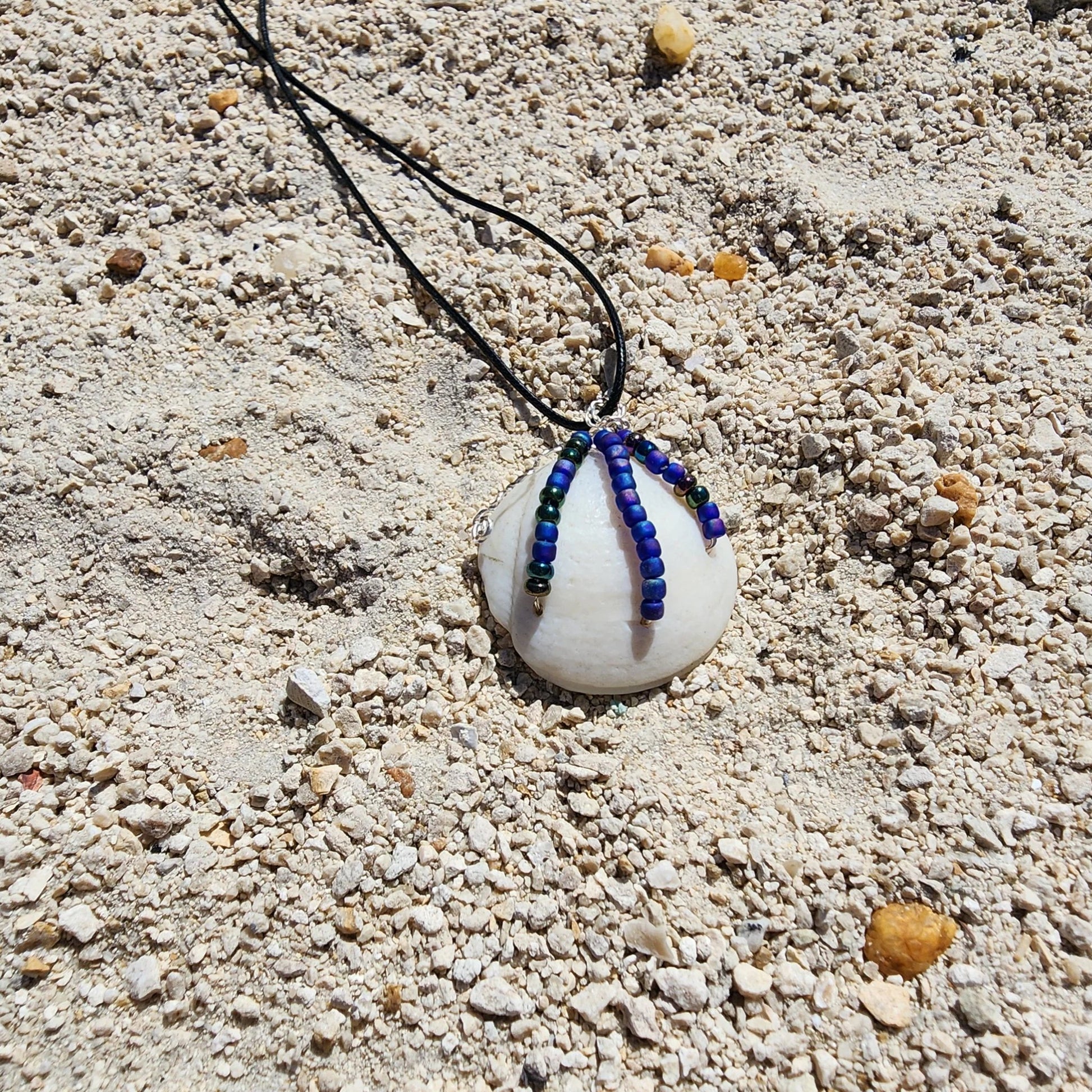 Handmade Lucina shell pendant necklace with silver wire wrap and multicolor bead strands