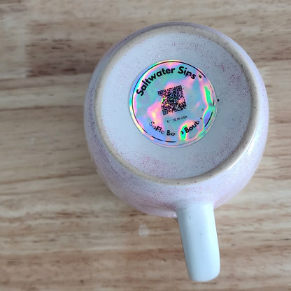 Bottom view of handmade ceramic coffee mug on wood surface