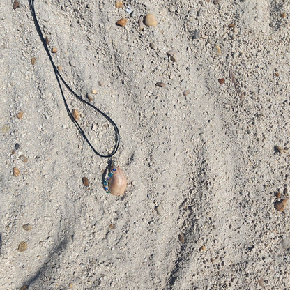 Handmade seashell pendant necklace frontside with silver wire wrap and blue green beads