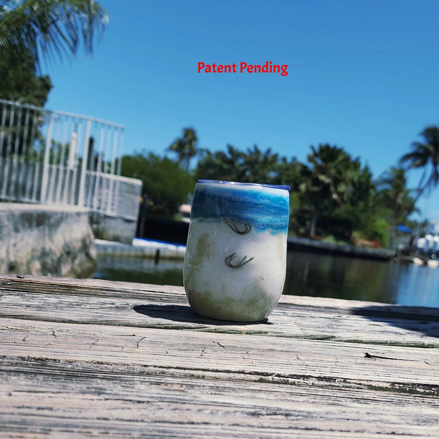 Ocean Fade Hook & Tumble™ 12oz wine tumbler on dock – hand-painted blue to white fade with real fishing hooks and sand handmade South Florida