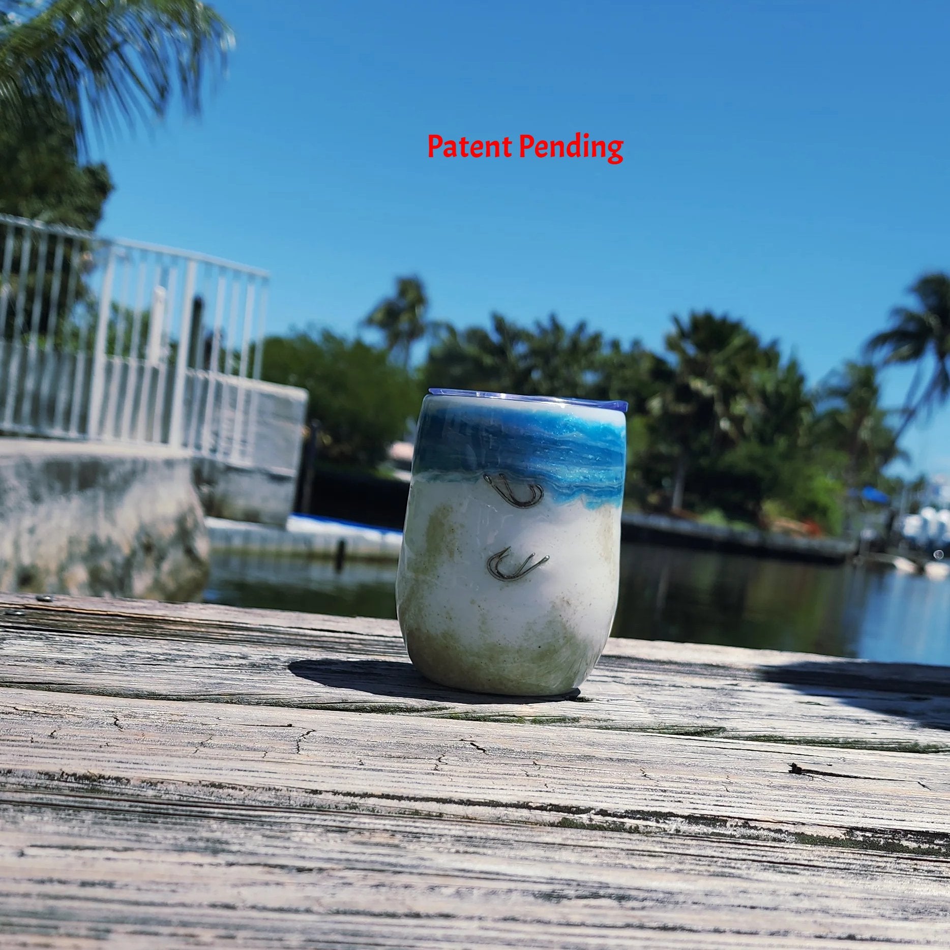 Ocean Fade Hook & Tumble™ 12oz wine tumbler on dock – hand-painted blue to white fade with real fishing hooks and sand handmade South Florida