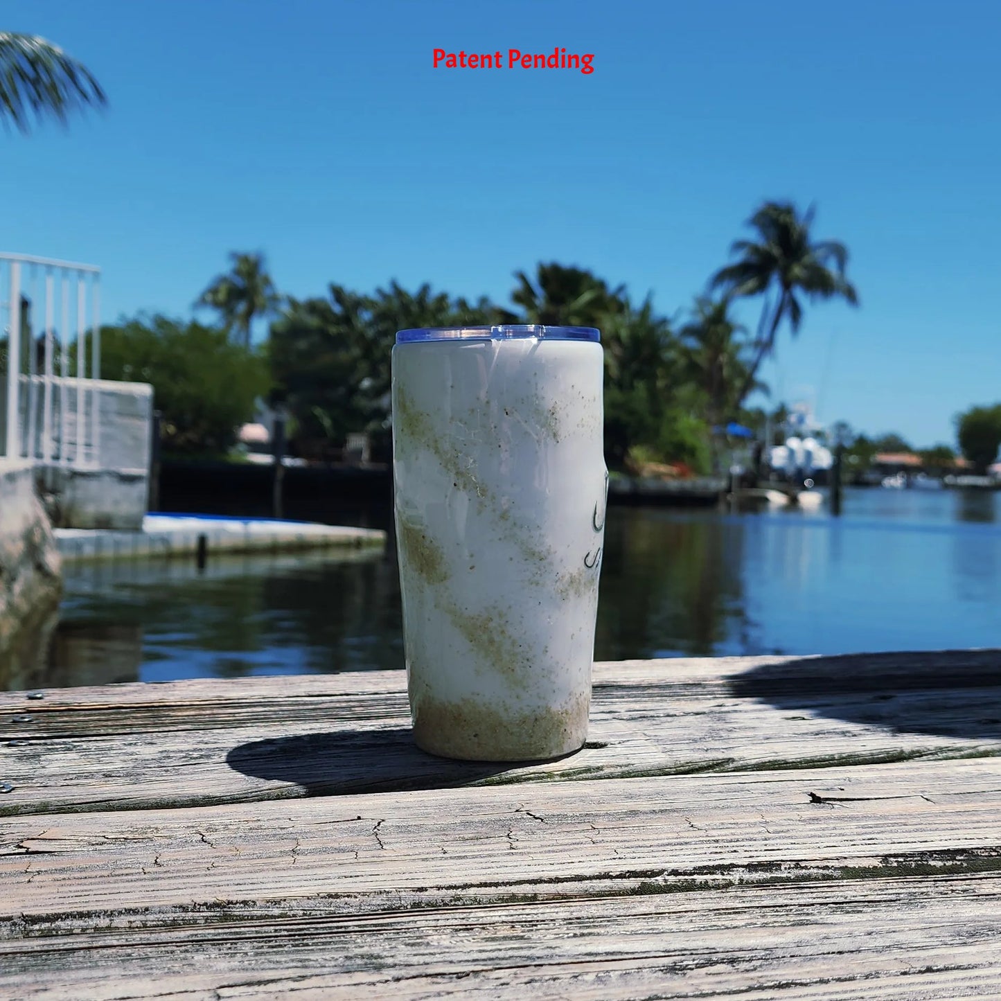 Side angle White Sands Hook & Tumble™ 20oz tumbler with intracoastal waterway background South Florida