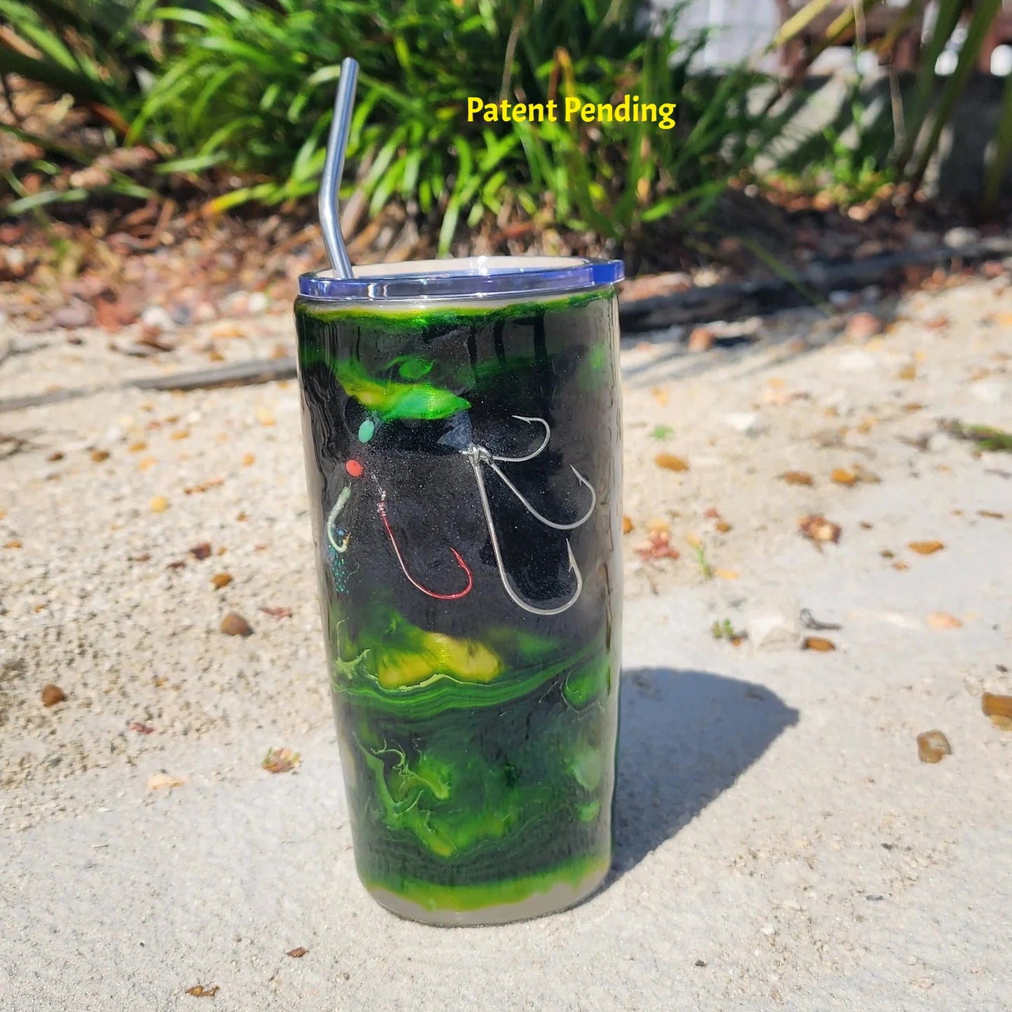 Close-up of Night Tide Green tumbler showing glow shrimp lure and bubble details with real metal hooks