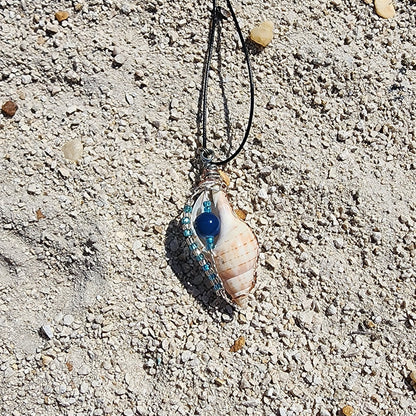 Handmade tulip shell pendant necklace with copper wire wrap, blue ceramic bead, and glass beads on cord