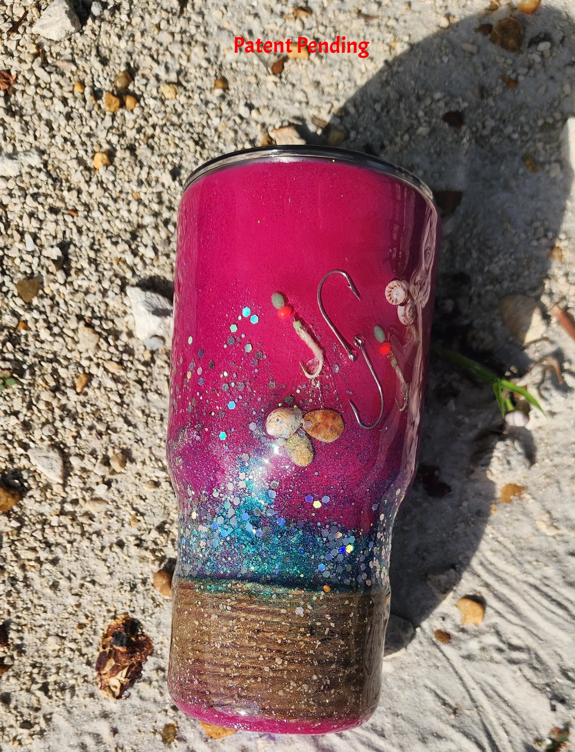 Hook & Tumble Magenta Tide tumbler close up showing real seashells and glow in the dark shrimp hooks in epoxy resin