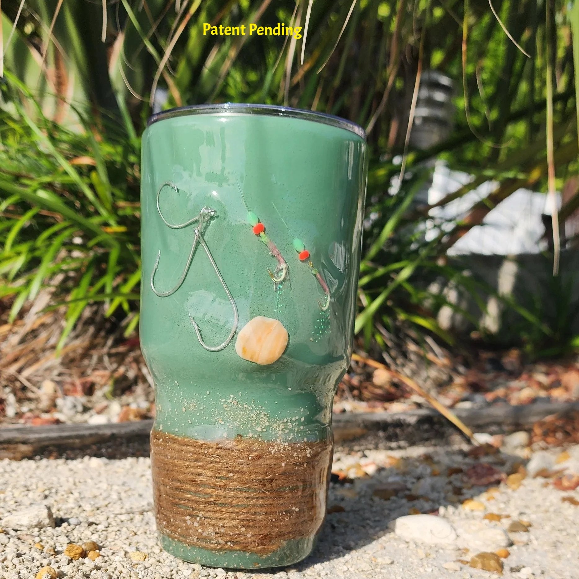 Marsh Tide 30oz Hook & Tumble fishing tumbler front view showing real fish hooks, glow in the dark shrimp hooks and seashell in crystal clear resin with natural rope wrapped base