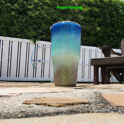Back view of Caribbean Glow Shell Glitter 30oz tumbler showing full deep cobalt blue to crystal turquoise to sandy shore design with holographic iridescent glitter throughout. Saltwater Sips™ by SoFlo Boho Boutique, handcrafted in South Florida, Patent Pending.