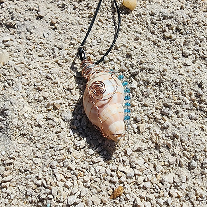 Handmade tulip shell pendant necklace with copper wire wrap, blue ceramic bead, and glass beads on cord