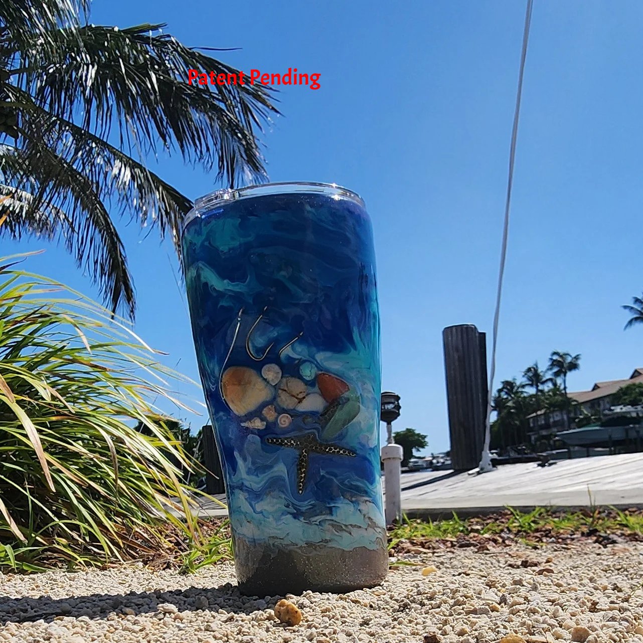 Blue ocean Hook & Tumble™ 20oz tumbler front view, real fishing hooks seashells starfish howlite sea glass, shimmer finish, Patent Pending