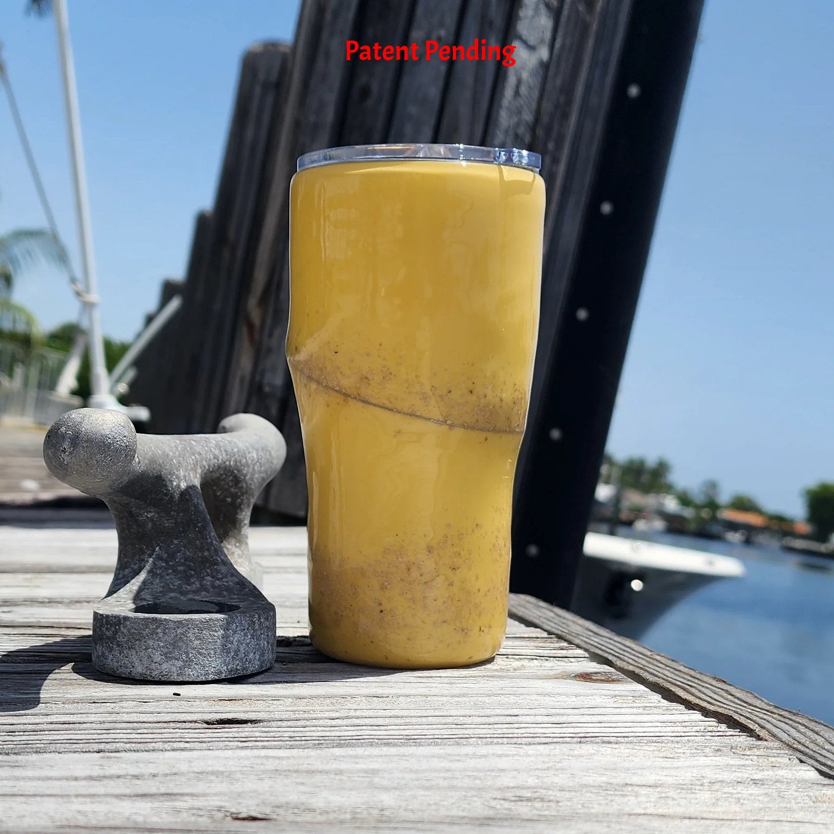 Golden Hour 20oz Hook & Tumble fishing tumbler back view showing golden yellow, dock and boat in background