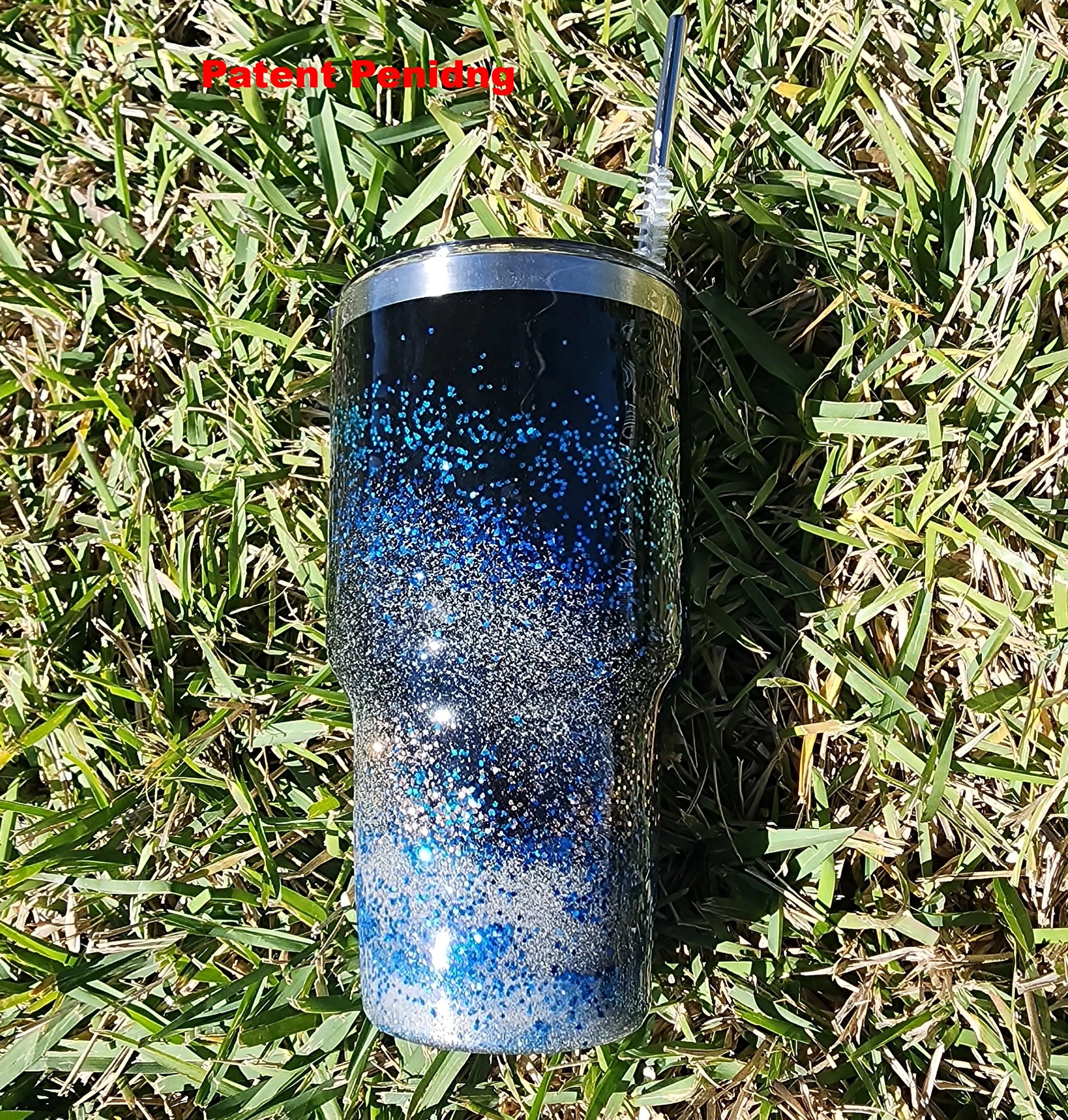 Saltwater Surge 30oz fishing hook tumbler with layered blue glitter and real sand epoxy design on beach