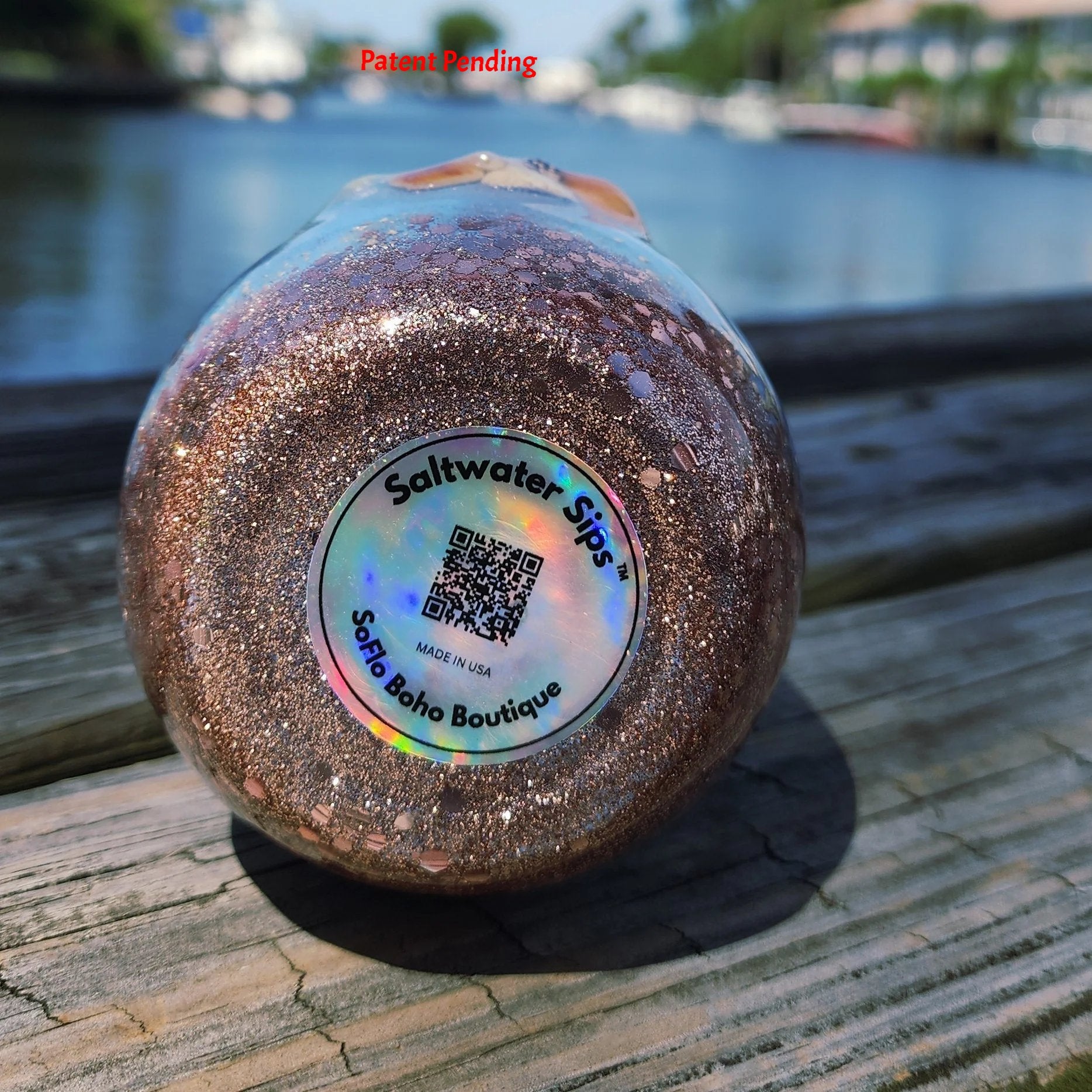 Bottom of Saltwater Sips 12oz tumbler showing handmade label, patent pending coastal epoxy drinkware