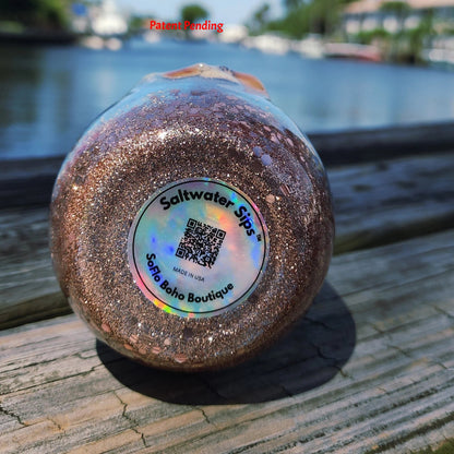 Bottom of Saltwater Sips 12oz tumbler showing handmade label, patent pending coastal epoxy drinkware