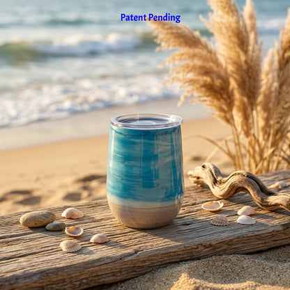 Teal 12oz insulated wine tumbler with a sandy base and pampas grass on the beach