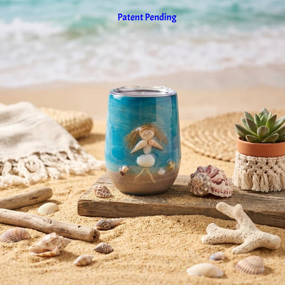 eal 12oz insulated beach tumbler with a shell person figure next to a small succulent on sand